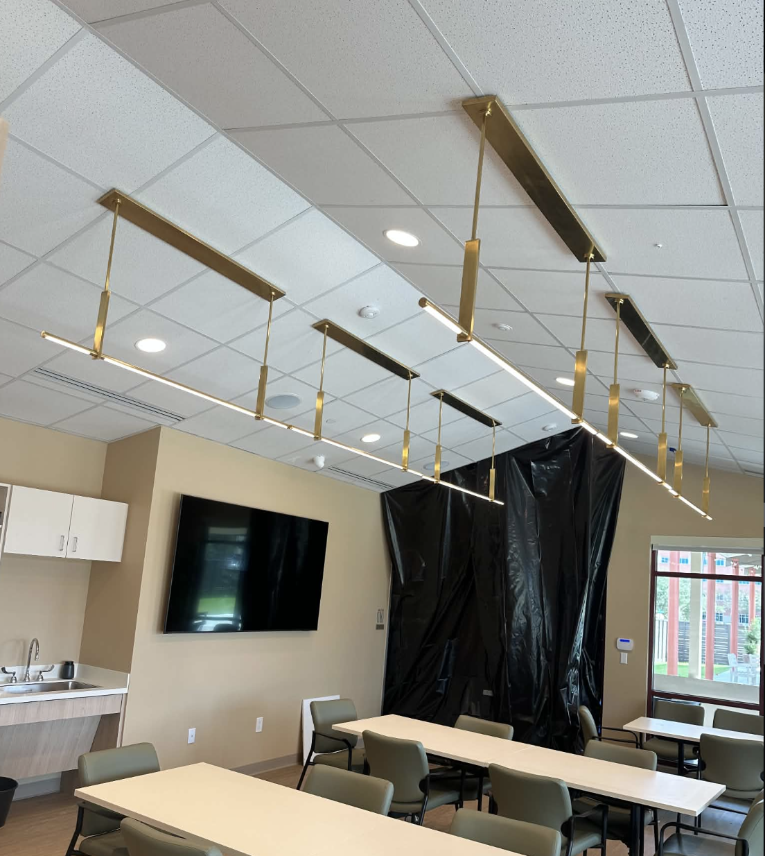 Linear brass pendant lighting installed by Thompson Electrical Solutions